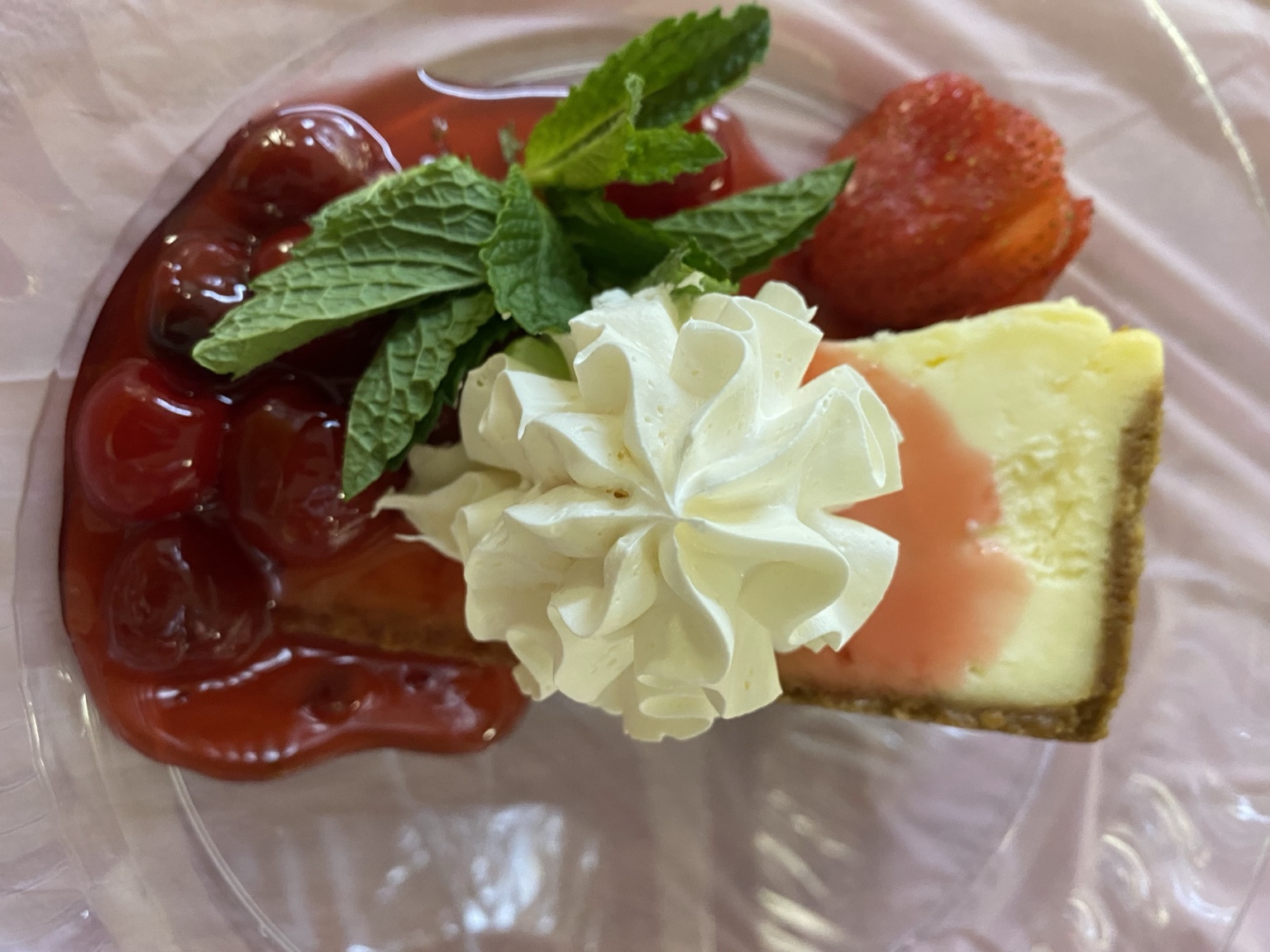 Classic cheesecake with freshly crafted cherry jubilee, hand-whipped cream, mint and strawberry